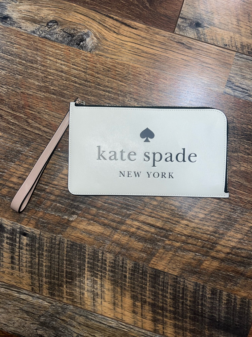 Kate Spade New York Cream Wristlet with Pink Strap